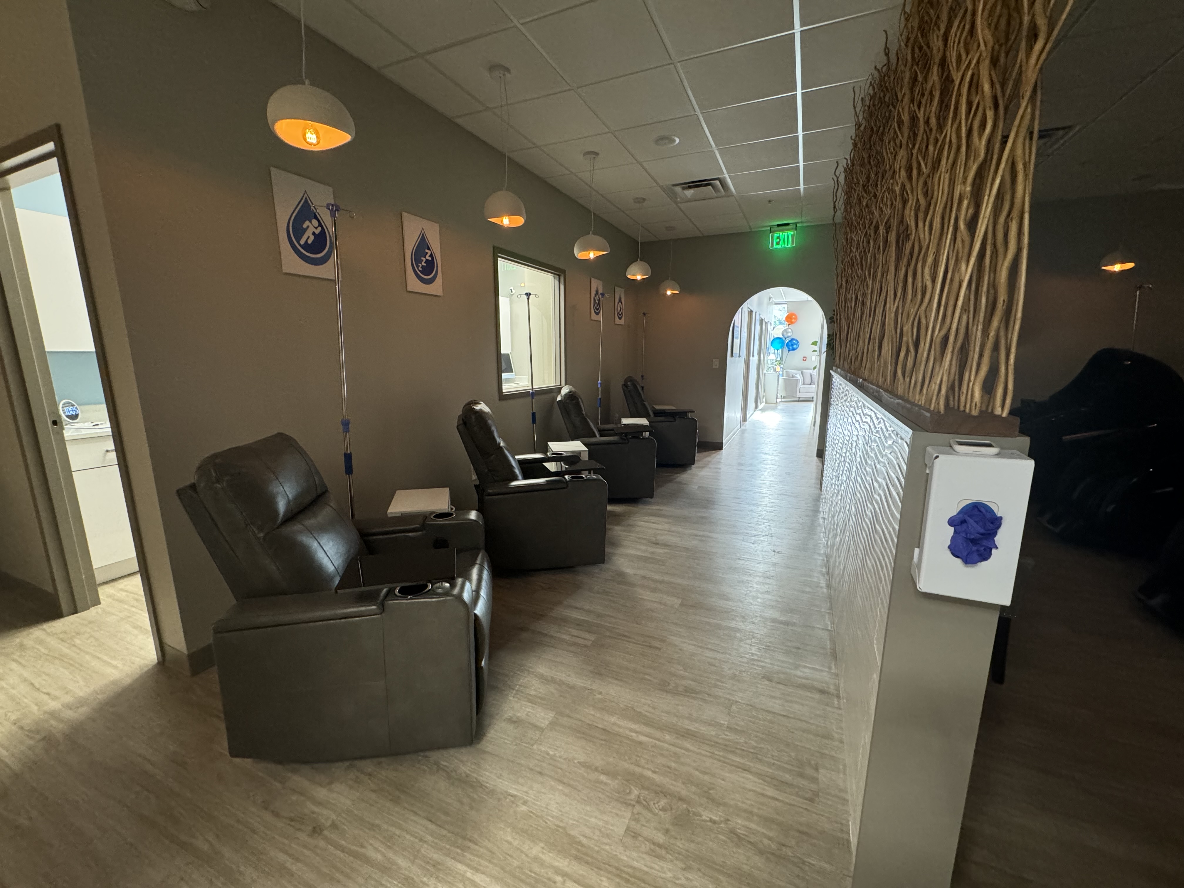 Comfortable leather recliners with IV drip poles in the relaxing treatment room at Prime IV Hydration & Wellness in Newport, KY