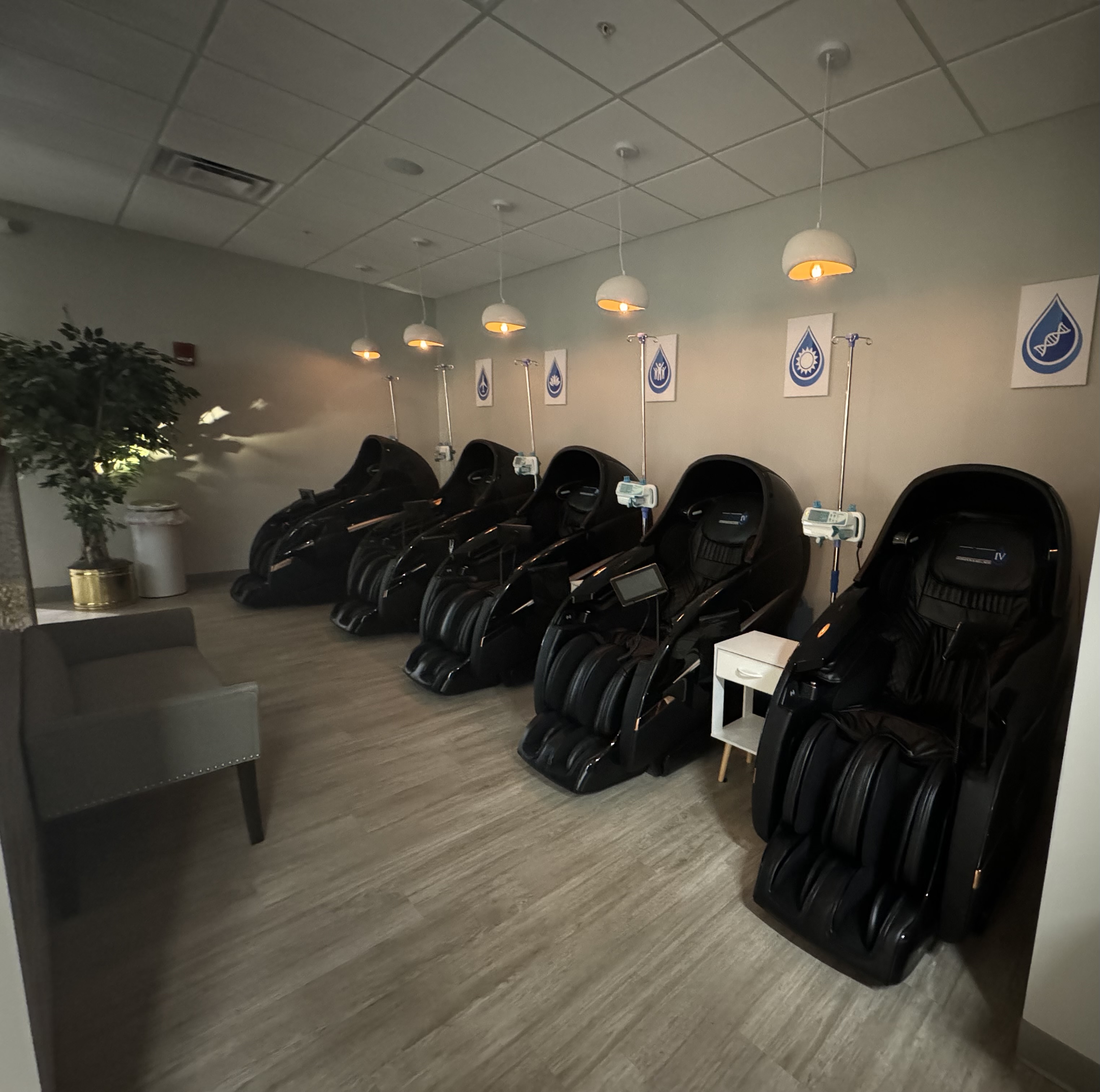 Prime IV Newport treatment lounge with a row of zero-gravity massage chairs and IV drip stations